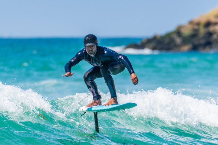 a man riding a wave on a surfboard in the ocean