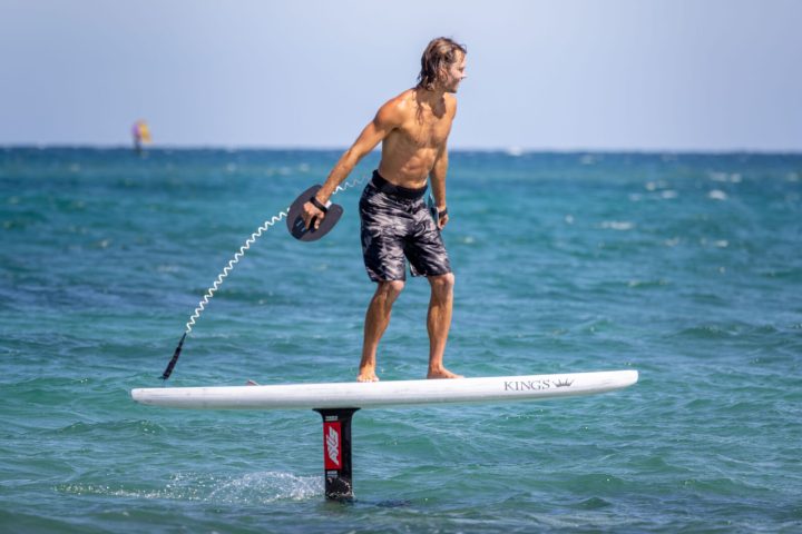 a person riding a surf board on a body of water